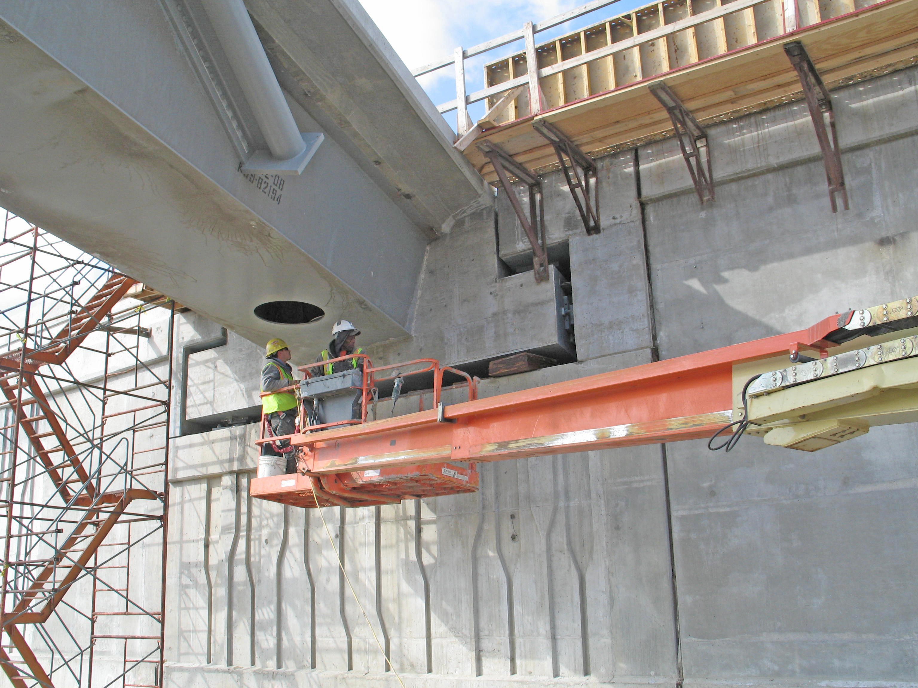 Two Cement Masons work on a bridge, part of the I75 Gateway Project.